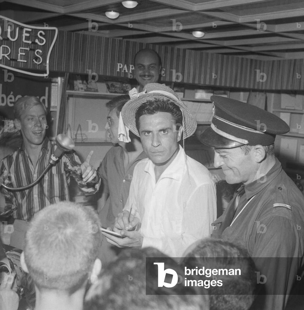 Gilbert Becaud signing autographs and discs in a bookshop in Nice, France, August 26, 1960 (b/w photo)