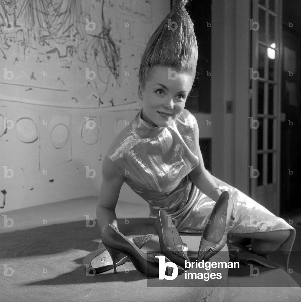 Presentation of Shoes Made By French Bootmaker Laure, The Model Has her Hair Done By Dessange, October 6, 1959 (b/w photo)