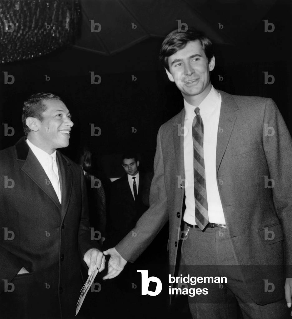 Singer Henri Salvador and Actor Anthony Perkins on December 18, 1963 (b/w photo)