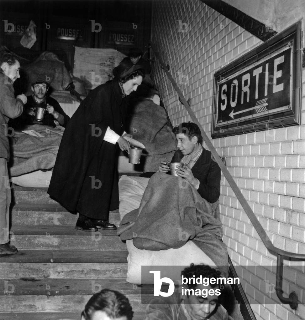 Hot drinks offered to Homeless People in The Subway in Paris, 1955 (b/w photo)