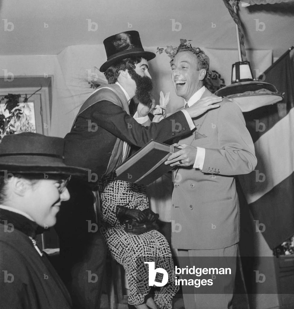 Saint Catherine's Day at Jacques Fath's fashion house, Paris, November 25, 1950 : Jacques Fath (r) (b/w photo)
