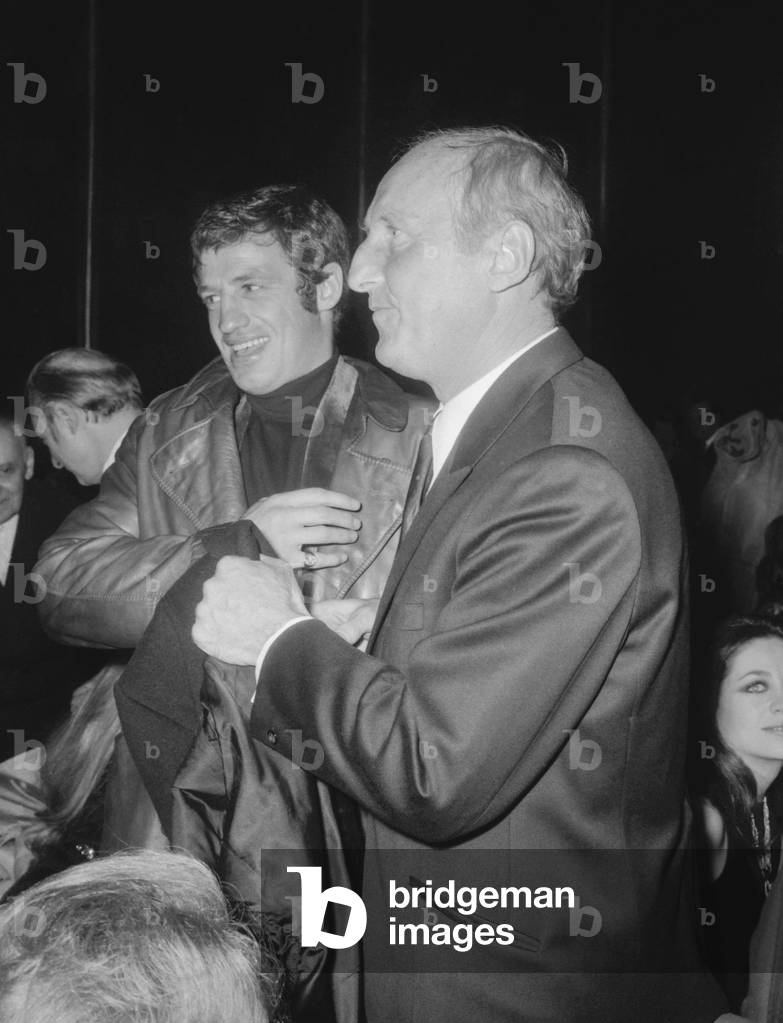 French actors Jean Paul Belmondo and Bourvil at the premiere of film 'The Brain' in Paris on March 7, 1969 (b/w photo)