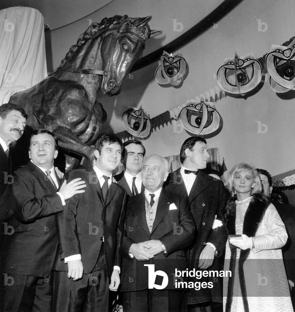 Premiere of Film Les Copains at Balzac Movie Theatre in Paris January 14, 1965 L-R Yves Robert, Pierre Mondy, Guy Bedos, Micheal Lonsdale, Jacques Balutin, Philippe Noiret, Christian Marin, Jules Romains and Daniele Delorme (In The Background The Statue of A Horse) (b/w photo)