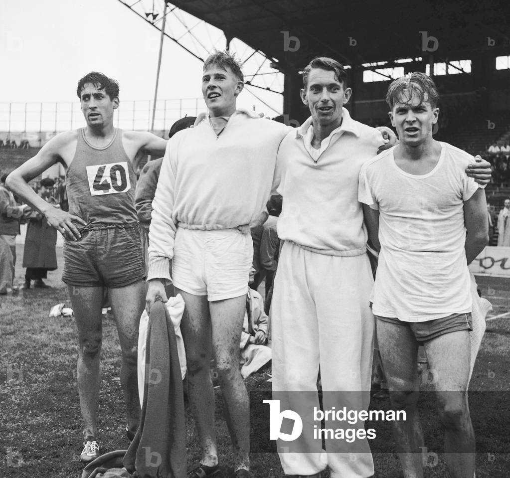 Meeting of athletism in Colombes, France, September 9, 1950 : here the athlets Marcel Hansenne (FR), John Parlett (GB), Roger Bannister (GB) and Michel Clare (FR) (b/w photo)