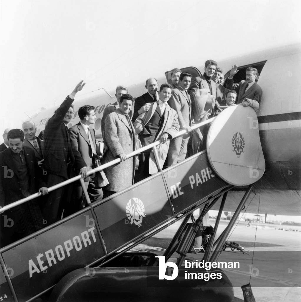 France Football Team Boarding For Lisbon L-R Mekloufi, Hainaut, Kaelbel (Arm Raised), Piantoni, Coach Batteux, Marche, Penverne, Jonquet, Colonna, Marcel, Vincent and Cisowski March 22, 1957 (b/w photo)