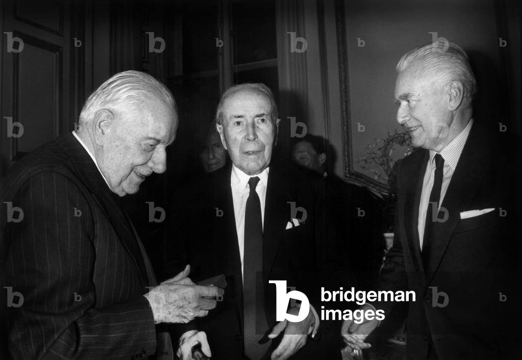 Alain Poher (L) Giving To Antoine Pinay The Gold Medal of Senate in Presence of Jacques Chaban-Delmas (R) in Senate, France, on November 27, 1991 (b/w photo)