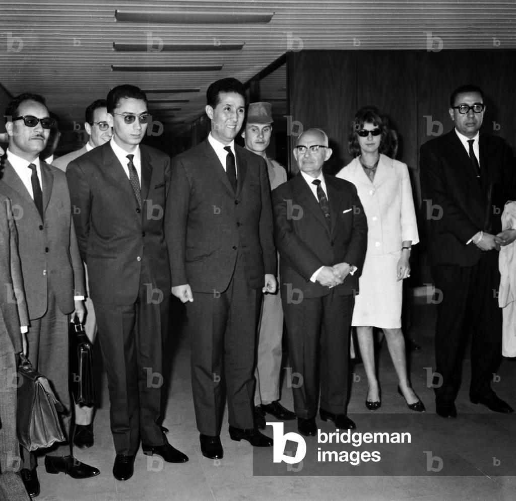 Ahmed Ben Bella, Algerian Politician, at Orly Airport in Paris Before Going in New York at Uno (Algeria Is Going To Join Uno). He'S With Ben Slimane (L), Fatima Nemiche and Hamed Yazid (Far R) (b/w photo)