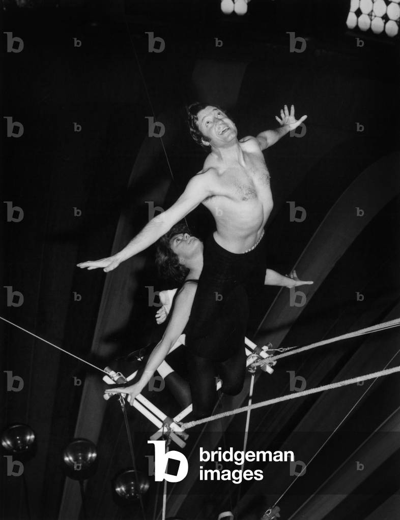 French Actor Jacques Sereys and his Wife Philippine Pascal (Philippine De Rothschild) during Rehearsal of A Trapeze Act in Paris For Gala of Artists, April 10, 1970 (b/w photo)