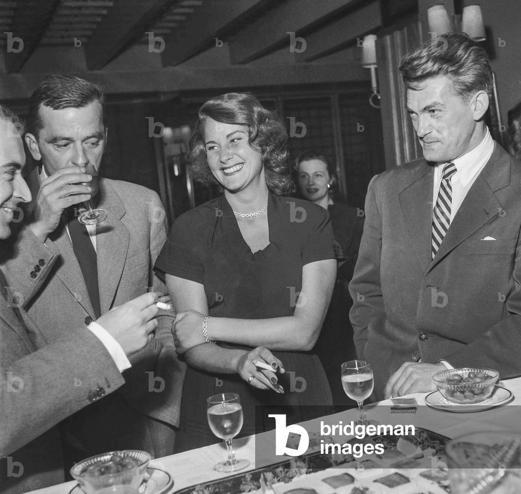 Jacques Sigurd, Yves Allegret, Allida Valli and Jean Marais during a cocktail given for the film Les miracles n'ont lieu qu'une fois