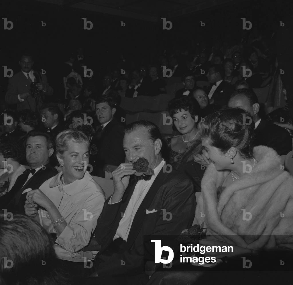 Gary Cooper (rose in mouth) with his wife and his daughter attending premiere of film 