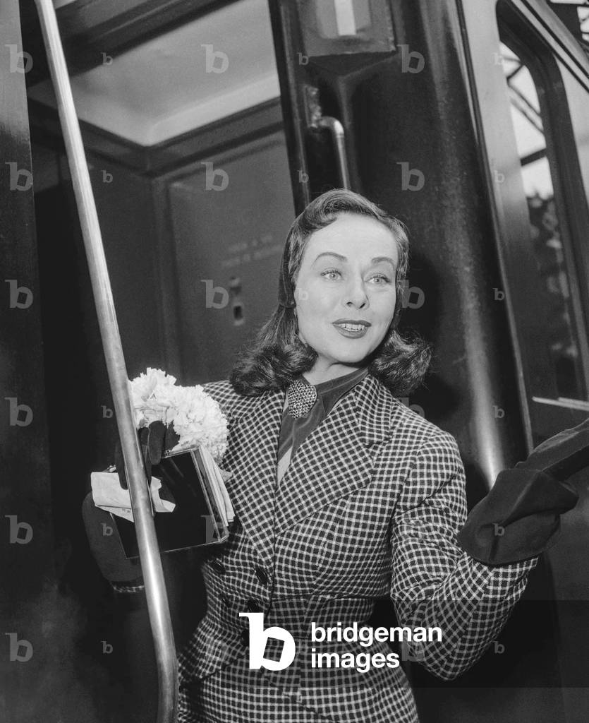 Actress Paulette Goddard at St Lazare station in Paris leaving for the USA, April 1950 (b/w photo)