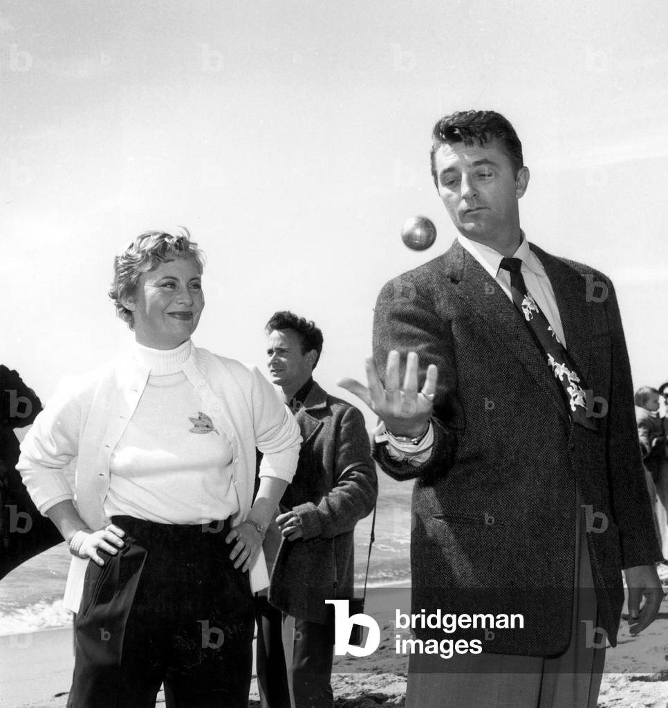 Michele Morgan and Robert Mitchum Playing Petanque at Cannes Film Festival March 26, 1954 (b/w photo)