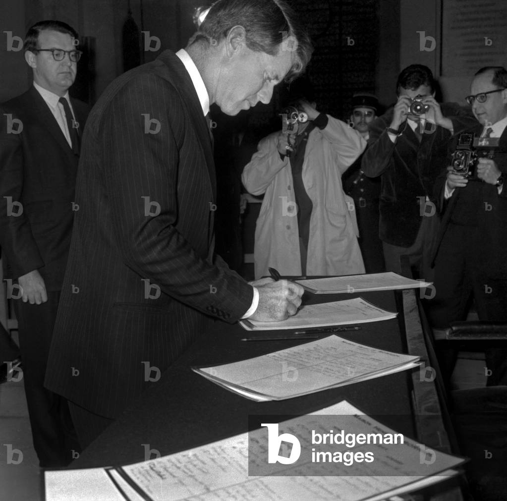 American Senator Robert (Bobby) Kennedy Signing Register at The Invalides in Paris January 31, 1967 (b/w photo)