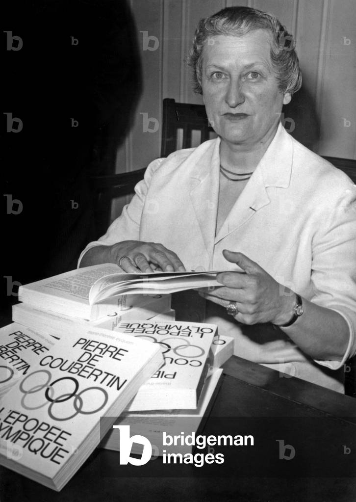 Marie Therese Eyquem Dedicating Her Book “Pierre De Coubertin L'Epopee Olympique” After receiving the Sports Literature Award offered by the Ministry of Youth and Sports on June 7, 1966 (b/w photo)