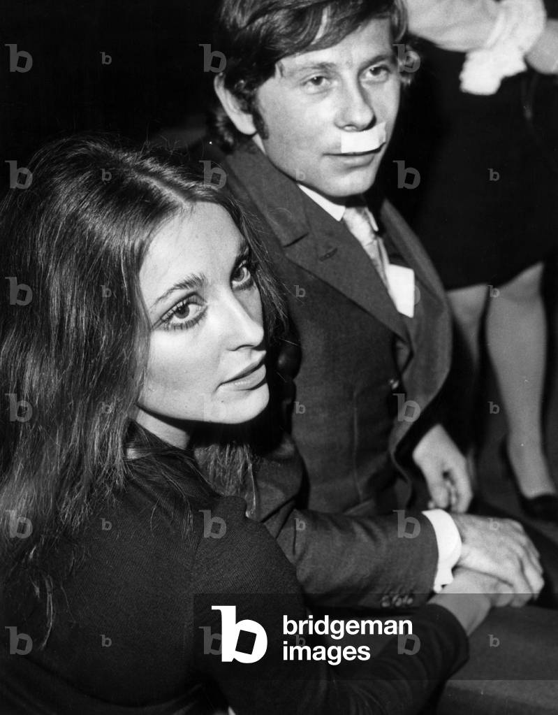 Sharon Tate and Roman Polanski at Premiere of Film The Fearless Vampire Killers in Paris January 31, 1968. Polanski Has A Plaster on his Lip Because He Fought Few Days Ago Because his Wife Was Disturbed By Lout Because of her Miniskirt (b/w photo)