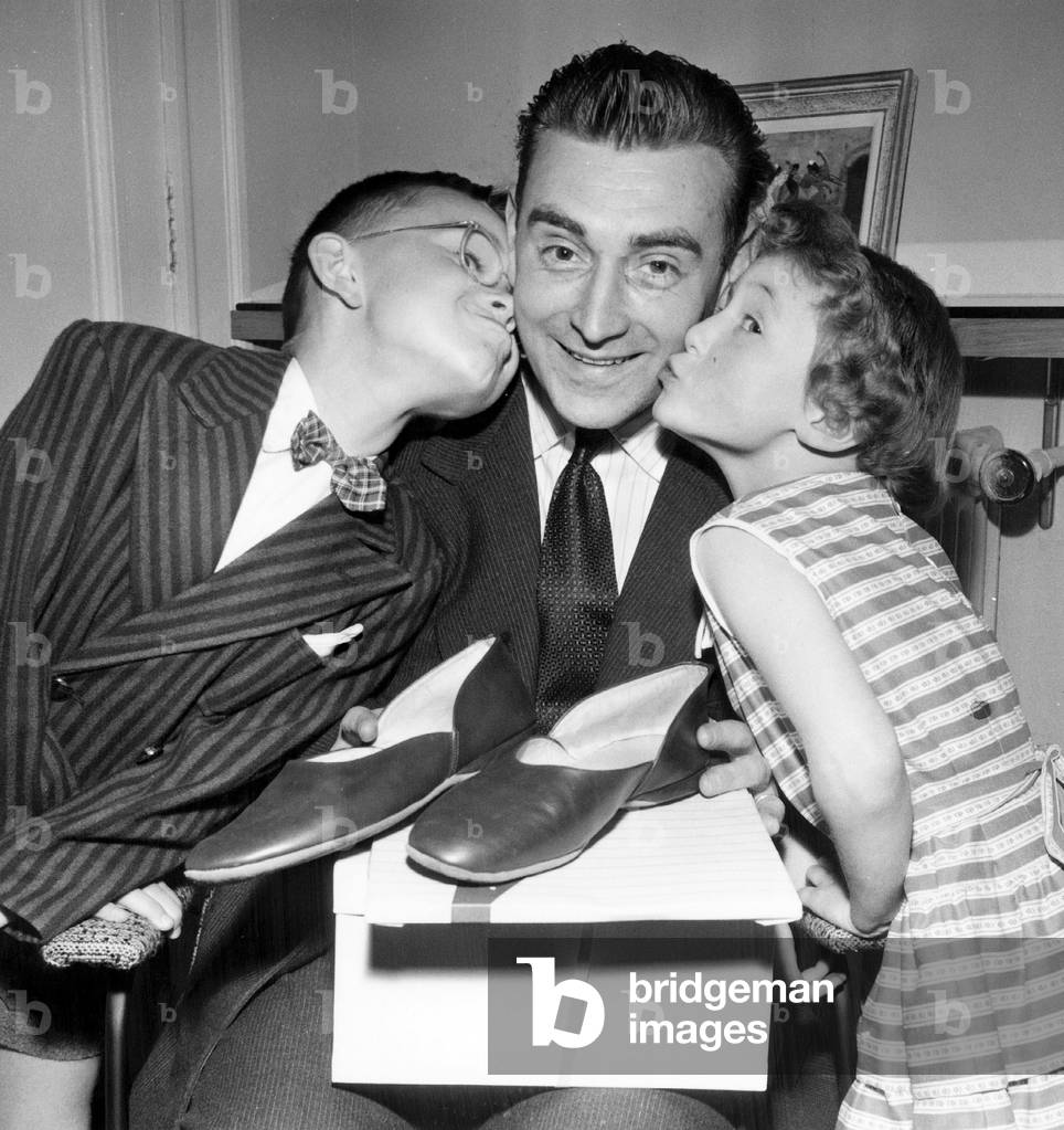 Children Kissing Their Father on Fathers' Day June 14, 1956 (b/w photo)