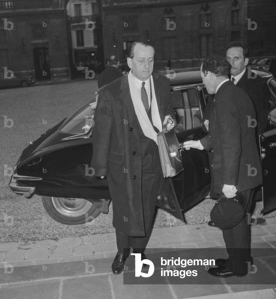 Andre Malraux, French Culture minister, arriving at the Council of Ministers, Elysee, Paris, December 8, 1960 (b/w photo)