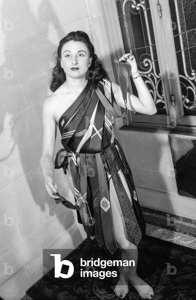The Night of the shirt trade in Paris (Claridge's), May 10, 1950 : French dancer Irene Guy presenting ties (b/w photo)