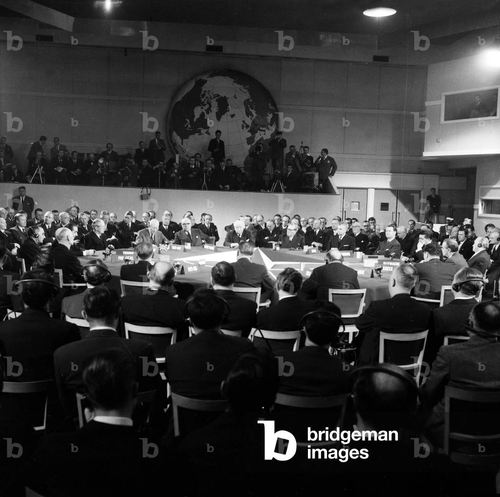 Nato Summit in Paris (Chaillot) on December 16, 1957 : Harold Macmillan, David Dwight Eisenhower (Speaking), Paul-Henri Spaak, Joseph Bech (Luxemburg), Achille Van Acker (Belgium), John Diefenbaker (Canada), Eric Ninn-Hansen (Denmark), Felix Gaillard (France), Conrad Adenaue (Germany), Constantine Karamanlis (Greece) (b/w photo)