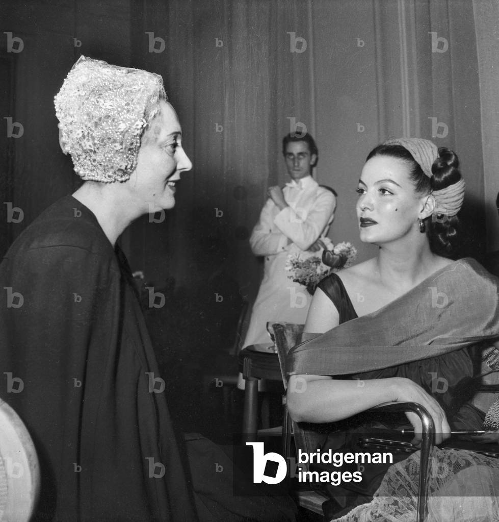 Actresses Arletty and Maria Felix during A Reception Given By Maria Felix, Hotel Georgev, Paris, March 11, 1949 (b/w photo)