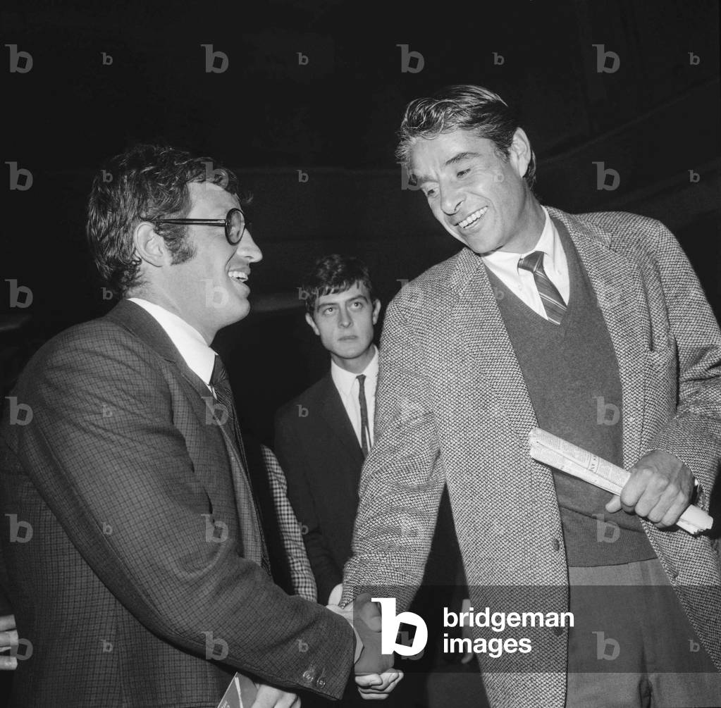 American tennis player Pancho Gonzalez (1928-1995) congratulating French actor Jean Paul Belmondo at the premiere of film 'Ho!' on October 17, 1968 (b/w photo)