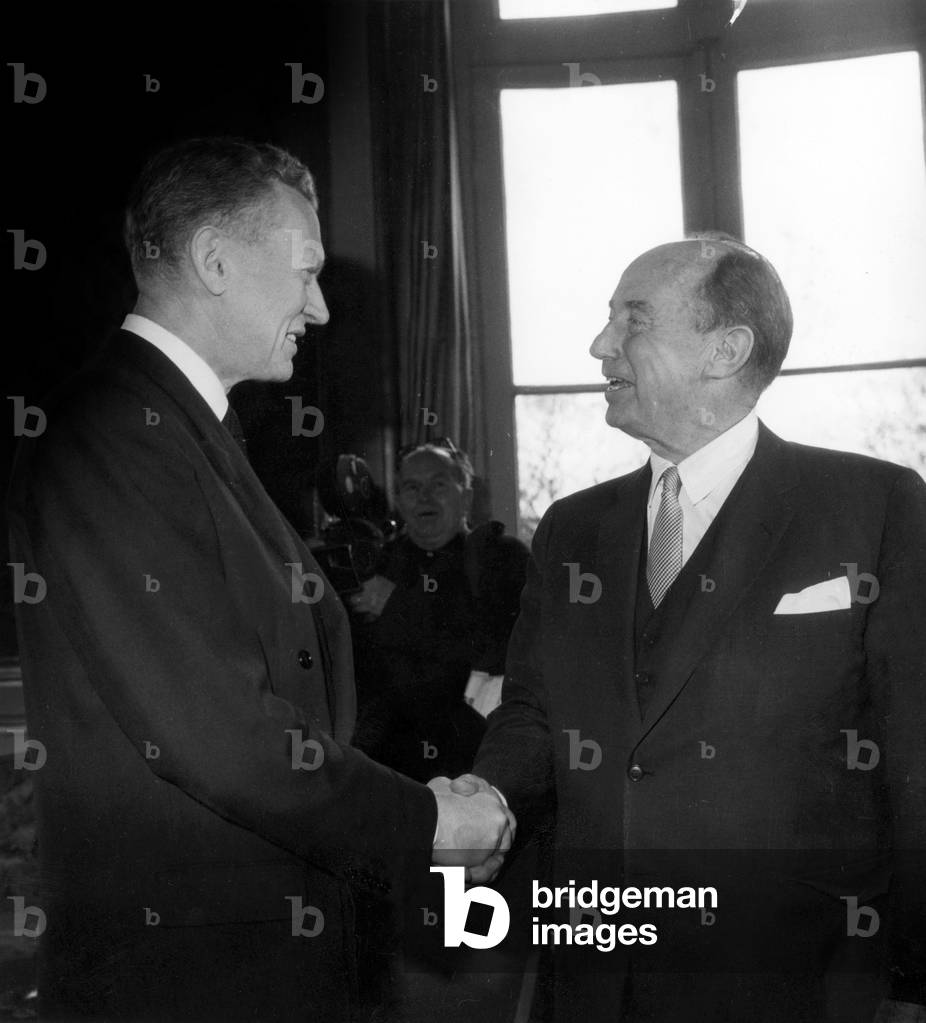 Adlai Stevenson, American Ambassador To United Nations, Holding The Hand of Maurice Couve De Murville, French Minister of Foreign Affairs, in Paris on March 23, 1963 (b/w photo)
