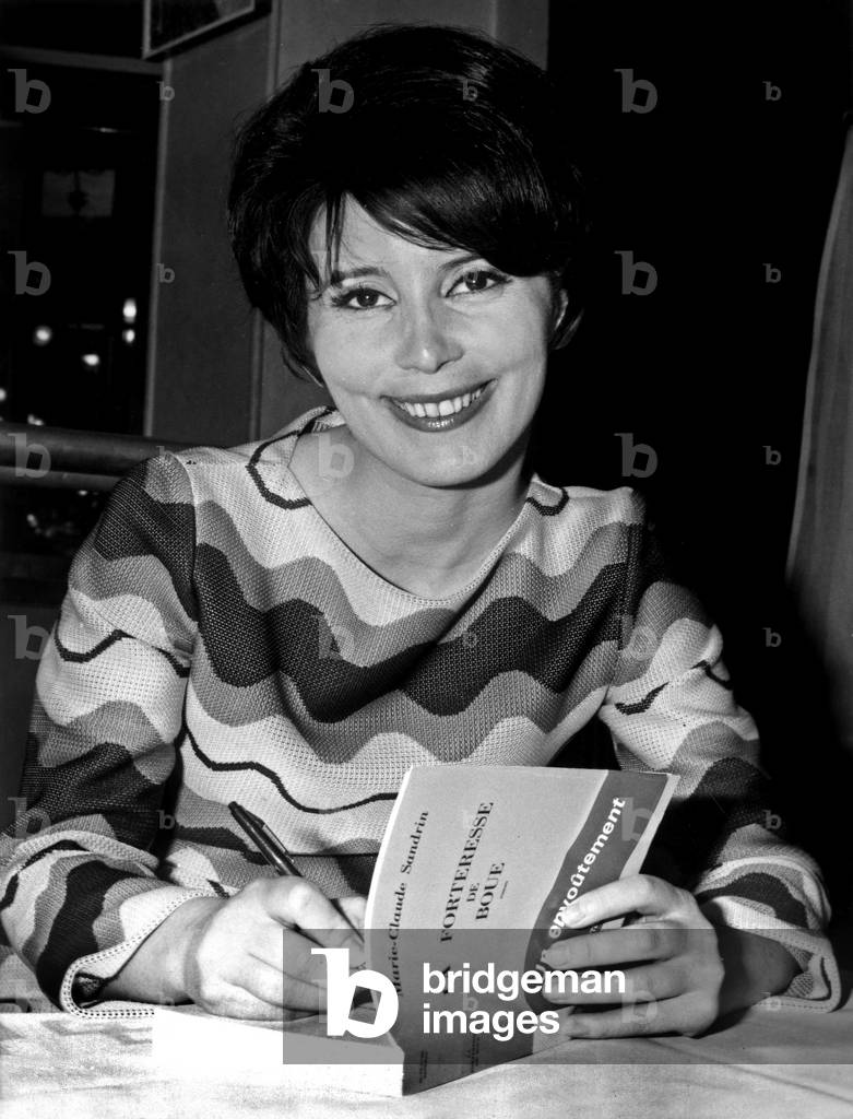 Marie Claude Sandrin Dedicating Her Novel “La Fortress De Mue” After Having received the 1967 Cazes Prize at La Brasserie Lipp April 21, 1967 (b/w photo)