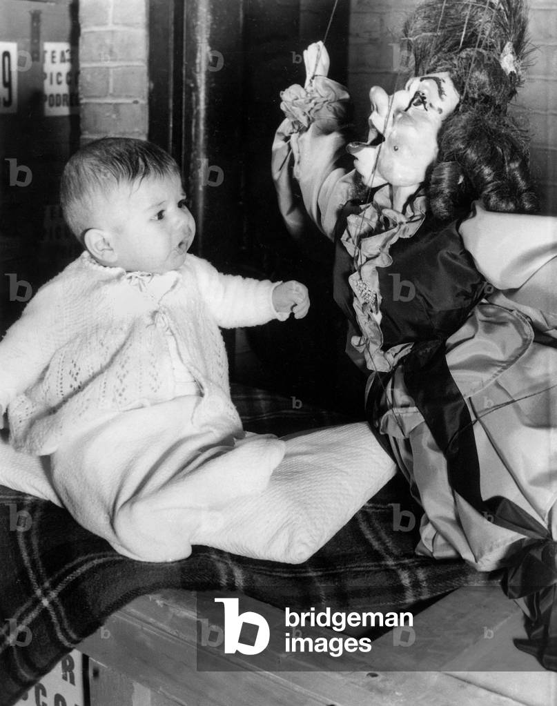Baby Looking at Puppet, 60'S (b/w photo)