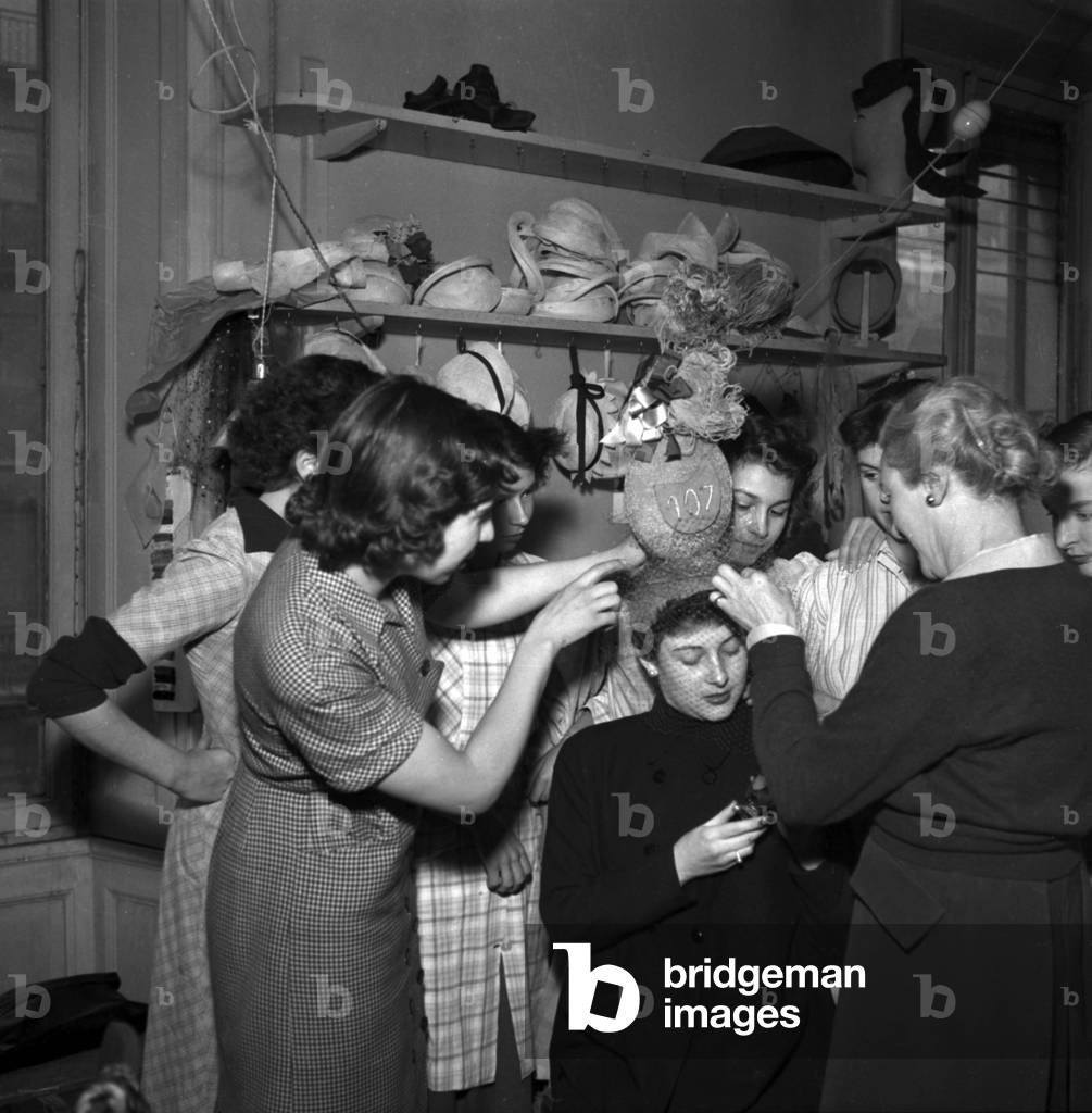 Young Woman in France in November 1952 on Saint Catherine Day : Holiday Made For Women Who Reach 25 Years of Age Without Marrying Which Symbolized Their Spinsterhood They Wore Unusual Hats To Show Their Status (b/w photo)