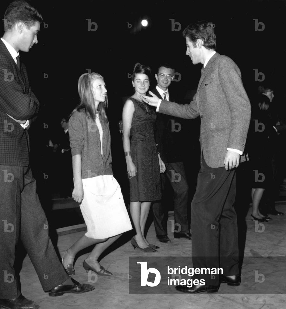 On October 4, 1964 : Preparation of The Ball of Debutantes Which Will Take Place in Chaillot Palace in Paris : Master of Ceremony Jacques Chazot Teaching To A Debutante To Curtsey (b/w photo)