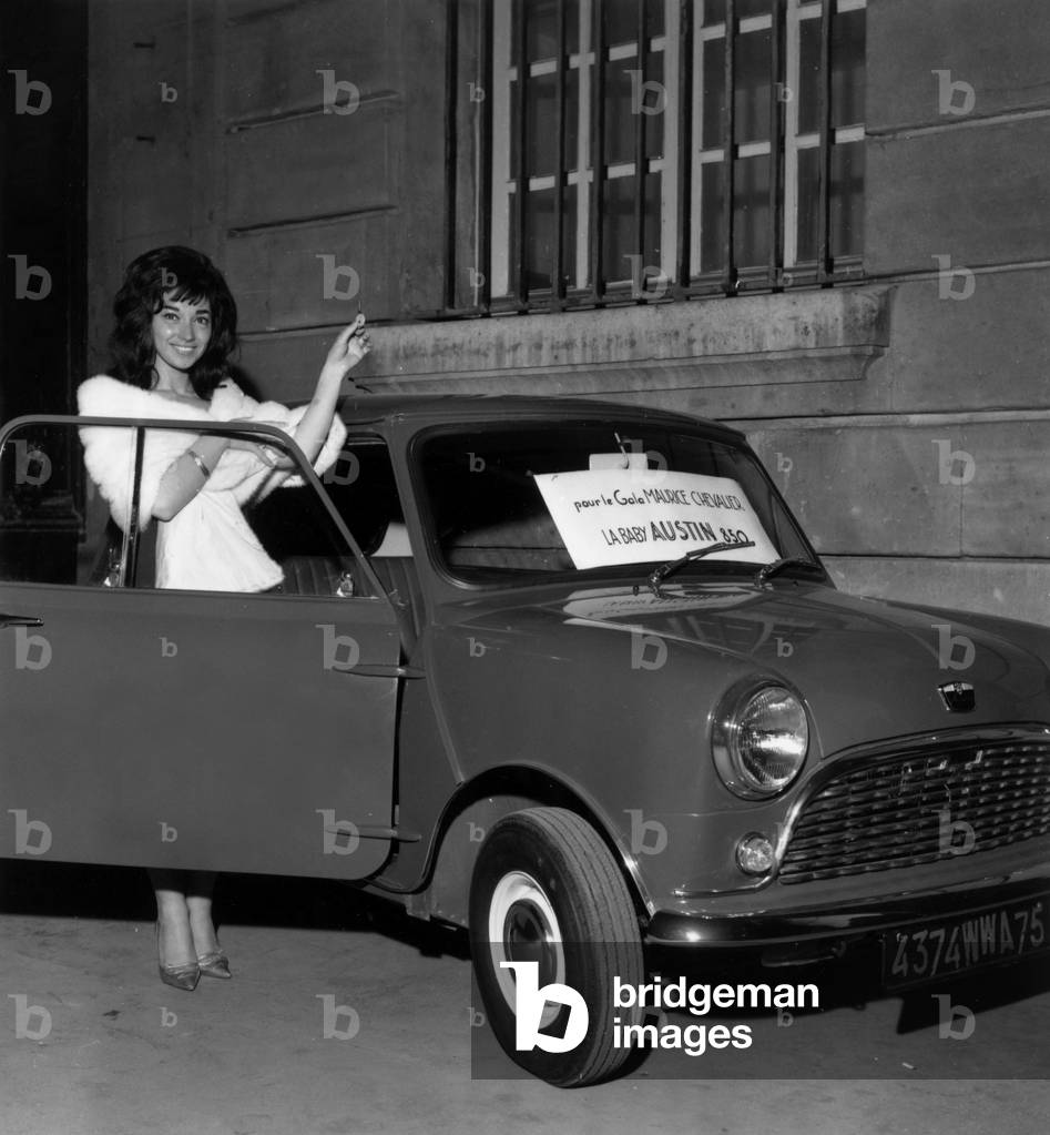 Singer Patricia Carli With Baby Austin 850 in Paris on Januray 28, 1965 (b/w photo)