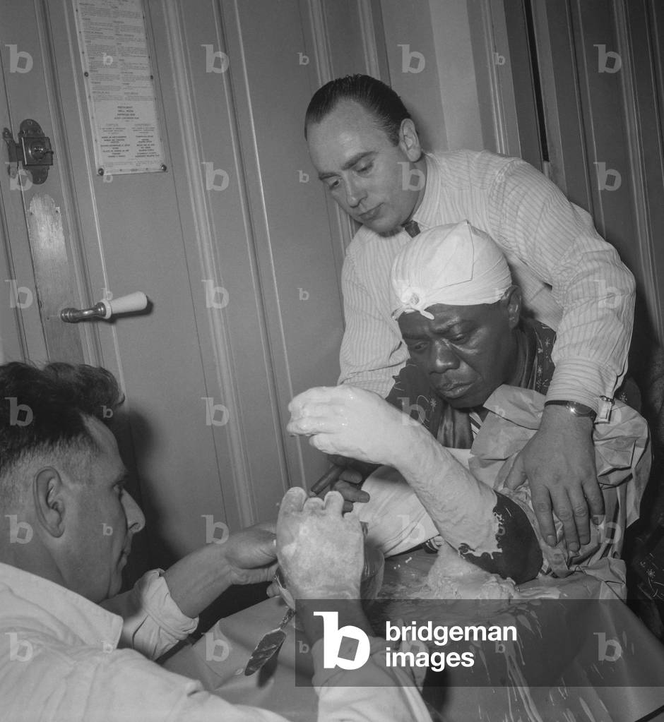 Casting of Louis Armstrong's hand, Paris, France, 1949 (b/w photo)