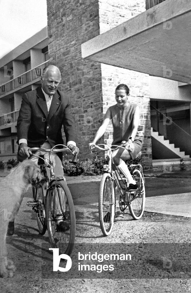 Curd Jurgens and his Wife Simone Bicheron Cycling during Their Holidays in Quiberon, France, July 13, 1968 (b/w photo)