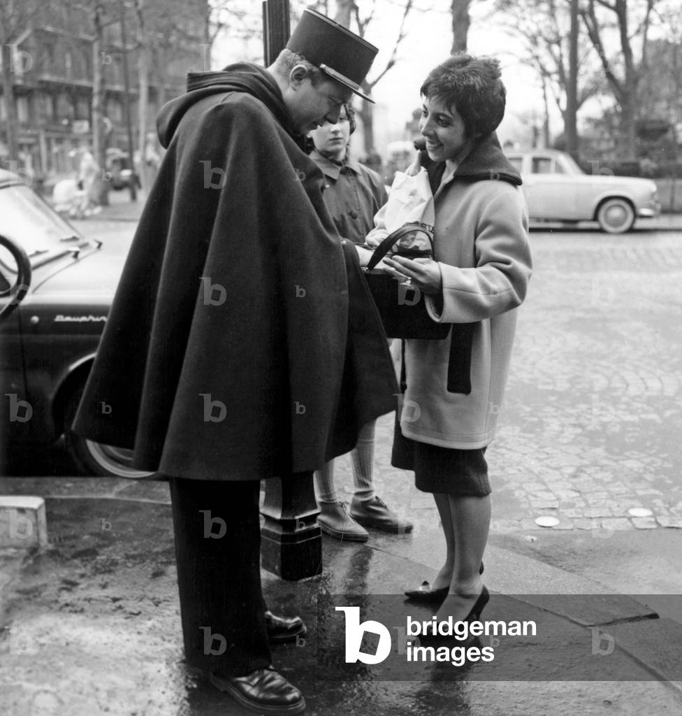 Police Check : A Policeman Checking Papers of A Woman and Looking in her Bag, Paris, February 16, 1962 (b/w photo)