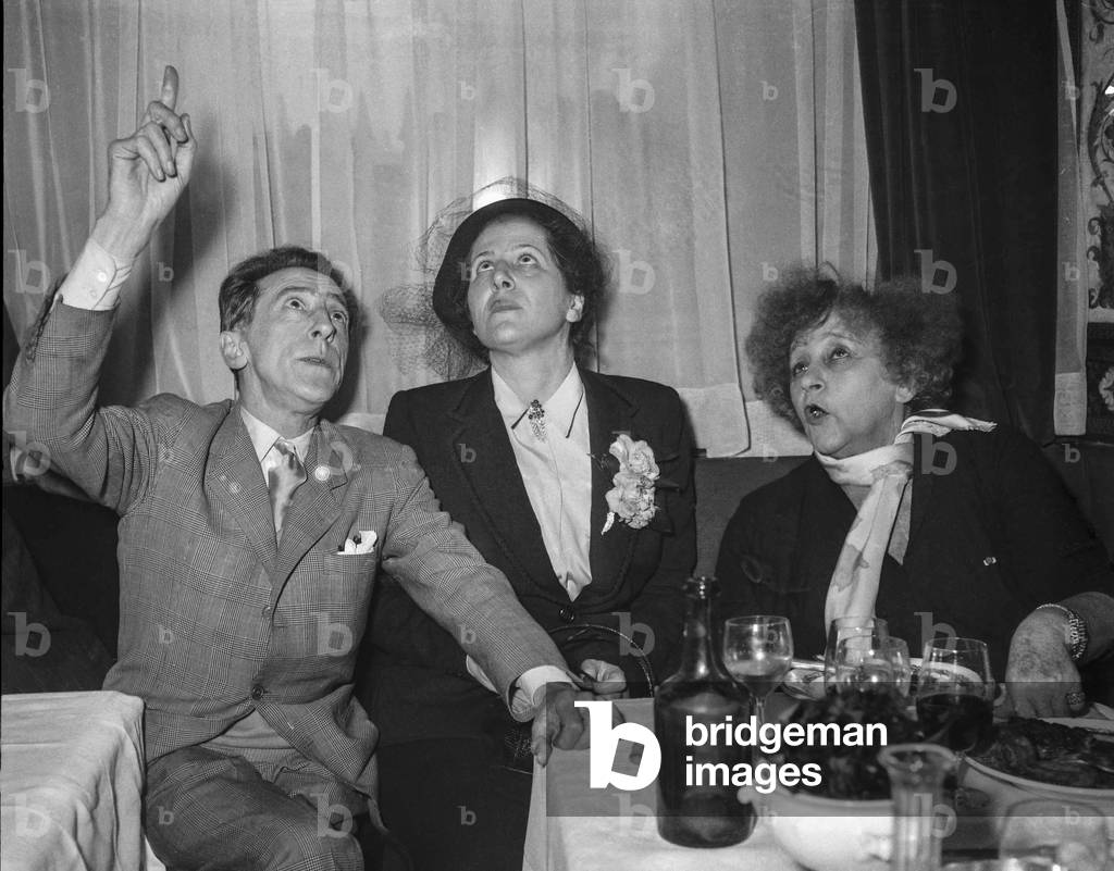 French writers Jean Cocteau, Suzanne Bidault et (Sidonie Gabrielle Colette, 1873-1954) in Paris on February 21, 1950 (b/w photo)