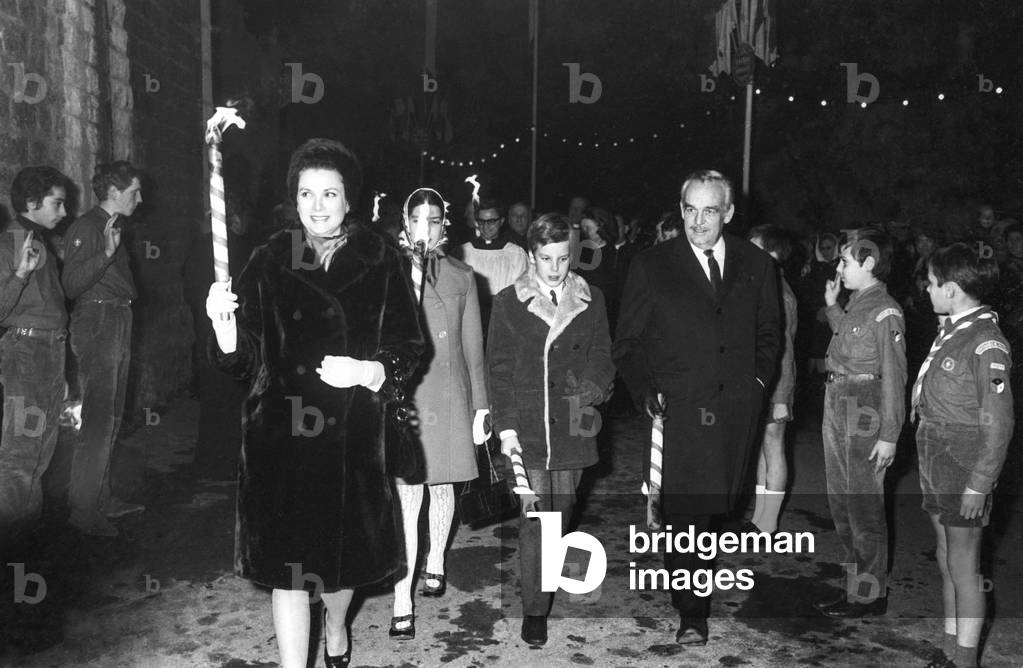 Princess Grace of Monaco, Princess Caroline, Prince Albert and Prince Rainier III of Monaco with boy scouts for the celebration of Sainte Devote in Monaco, January 29, 1970 (b/w photo)