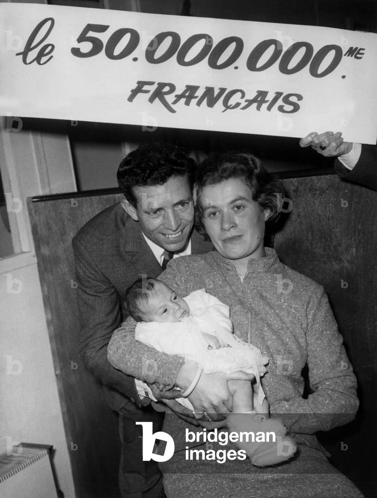 At the Salon De L Enfance Mr And Mrs Maurice Lemoine Son In The Company Of Little Sibylle Their Daughter After Being Elected By The Inse “50 Millionieme Francais” November 3, 1967 At the Parc Des Expositions De La Porte Deversailles (b/w photo)