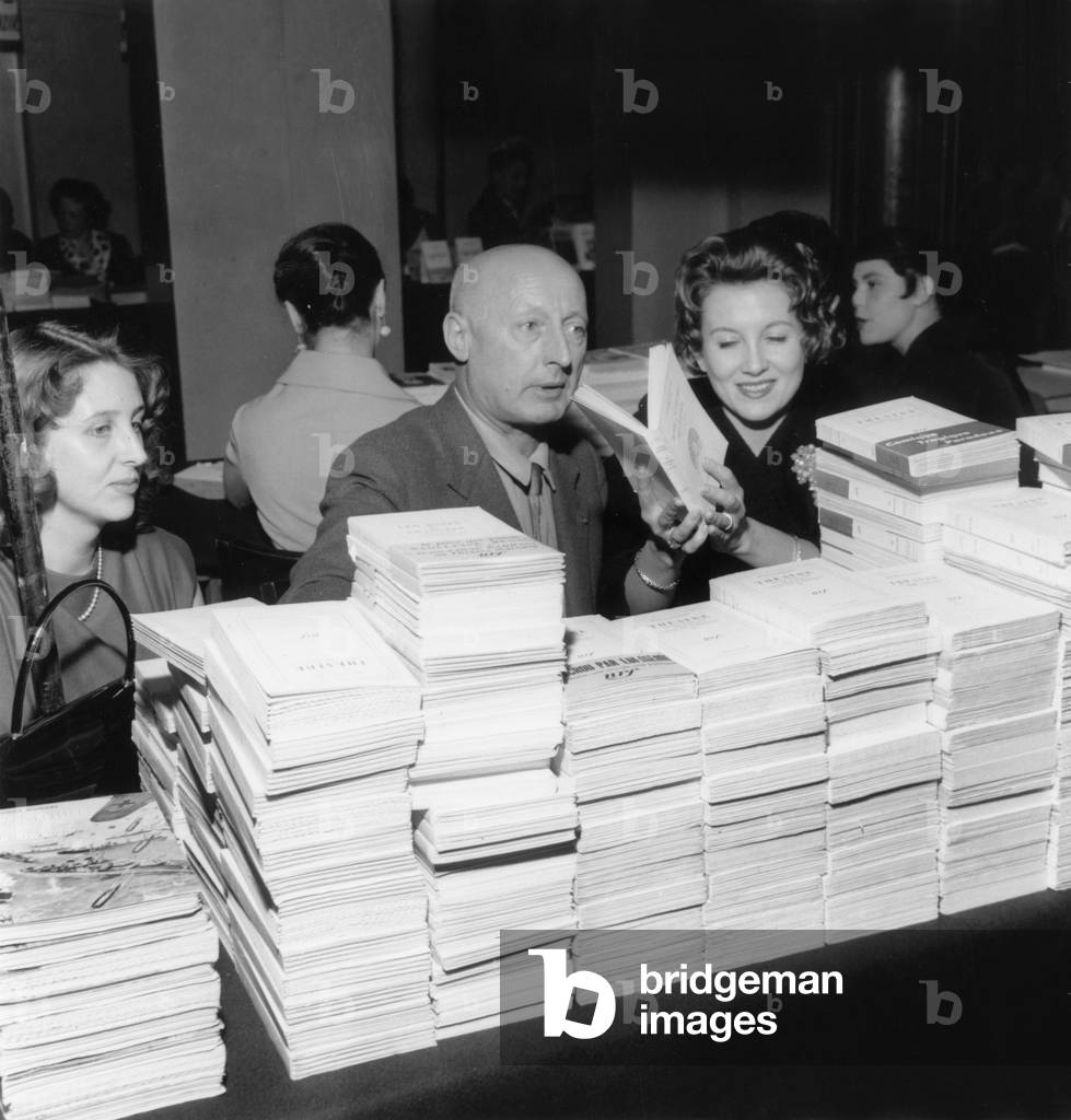 Marie Daems With Writer Armand Salacrou at A Book Sale on May 3, 1957 (b/w photo)