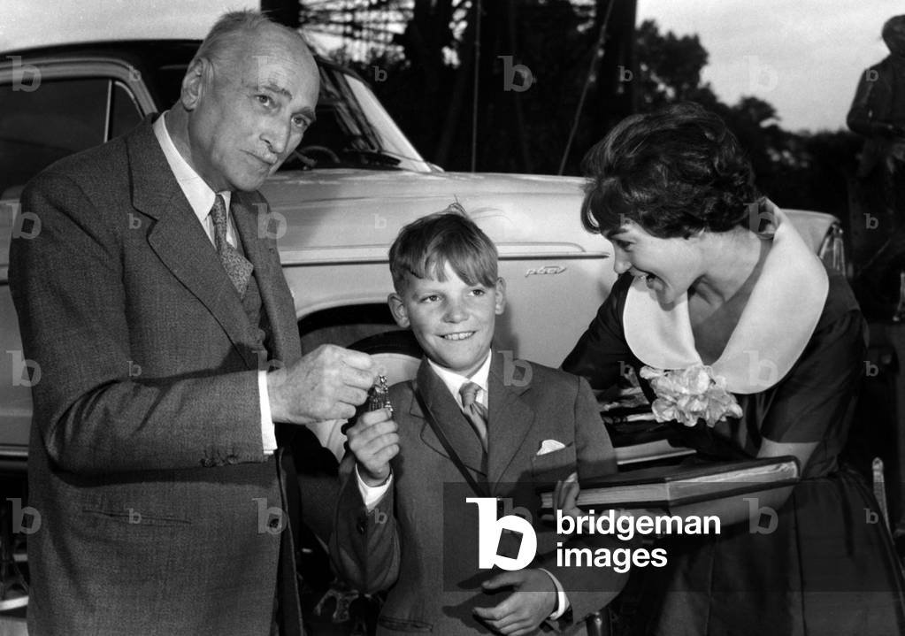 The 35000000Eth Visitor Of The Eiffel Tower A Young Rouennais Julien Bertin Here Receiving From Mr Legrain-Eiffel (Little Sons Of The Builder) The Keys Of A Car And Claudie Laurence A Book Relating The History Of The Celebre Tour June 30, 1959 (b/w photo)