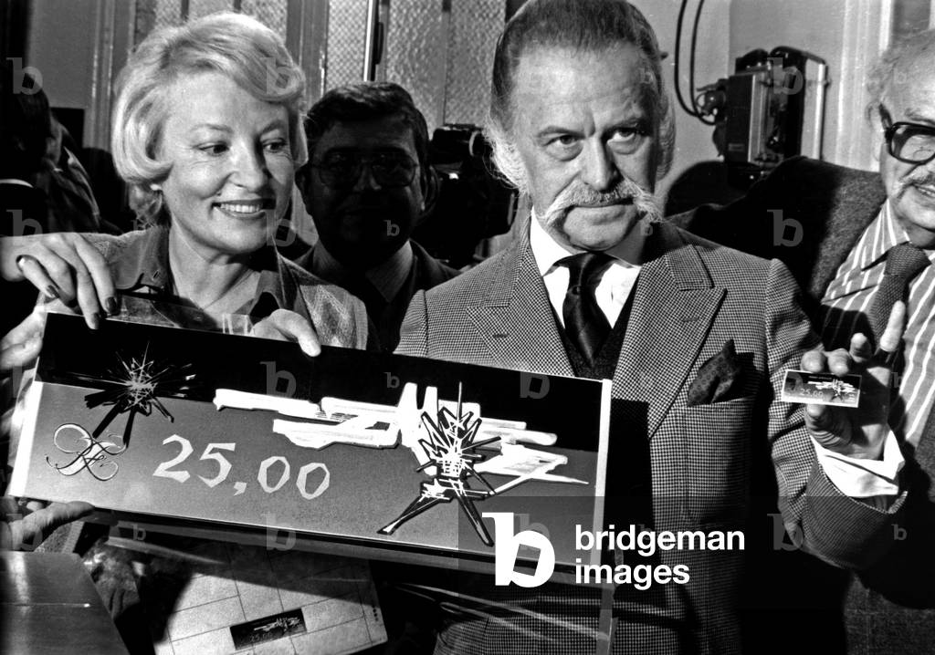 Painter Georges Mathieu Presenting his V For The French Southern and Antarctica Territory here With Philatelic Journalist Jacqueline Caurat October 14, 1982 (b/w photo)