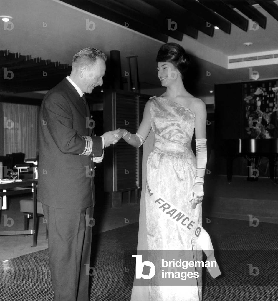 Nicole Lemaire, Miss France 1962, and Commandant Croisille, Commandant of Liner France, on December 31, 1961 (b/w photo)