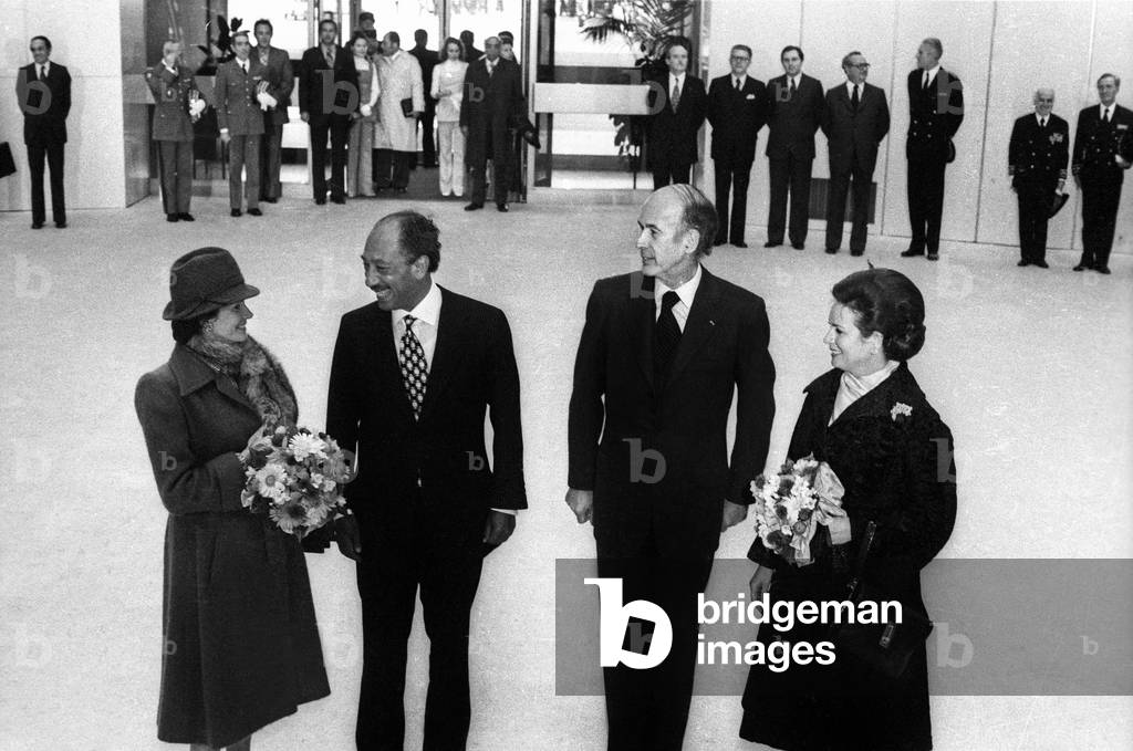 Egyptian President Anwar Sadat and his Wife Jehane Arriving at Paris Orly Airport Welcome By French President Valery Giscard D'Estaing and his Wife Anne Aymone January 27, 1975 (b/w photo)