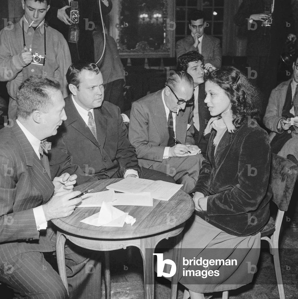 Director Orson Welles is looking for an actress to play Salome in his next film, at the Critton Club, Paris, January 15, 1952 (b/w photo)