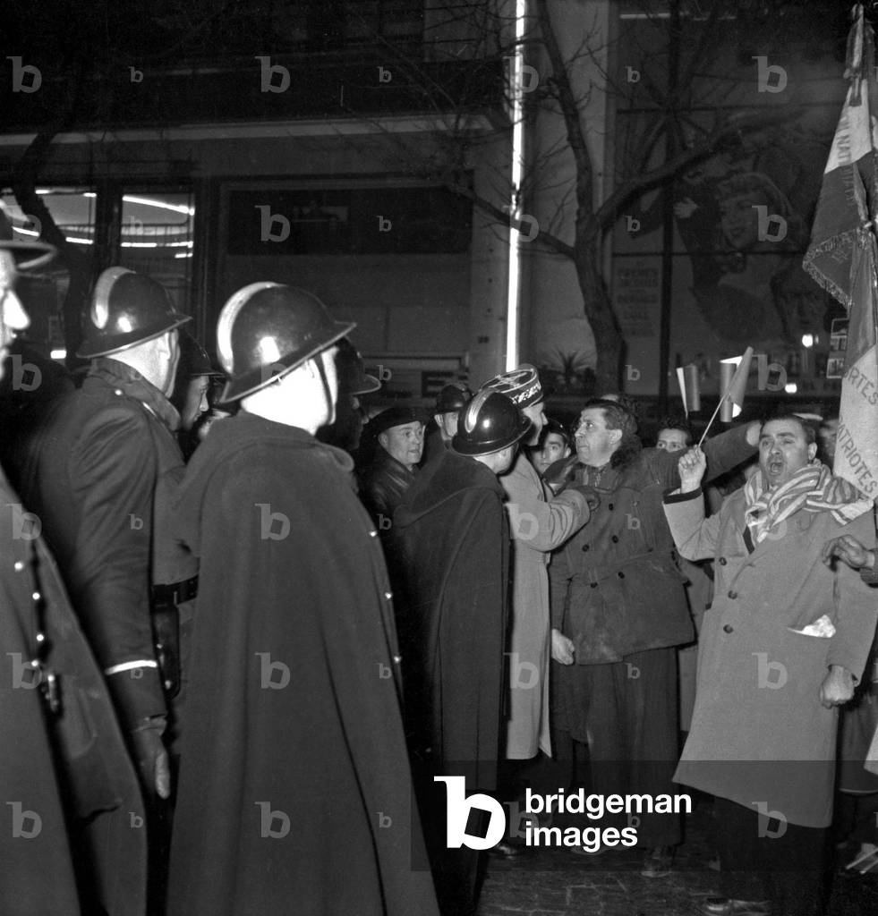 Communist Demonstration in Paris on February 15, 1951 : Members of The National Federation of Interned, Resistants, Victims of Deportation Demonstrating Against Visit in Paris of German Delegates To Attend A Conference About Constitution of An European Army : Policemen and Demonstrators (b/w photo)