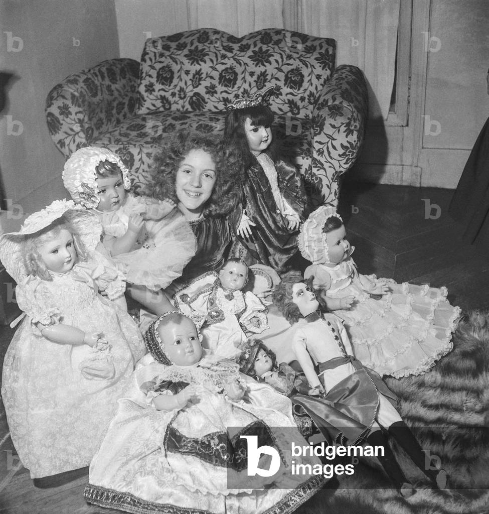 Young French actress Lucie Valnor with her dolls (given by her admirers), February 6, 1951 (b/w photo)