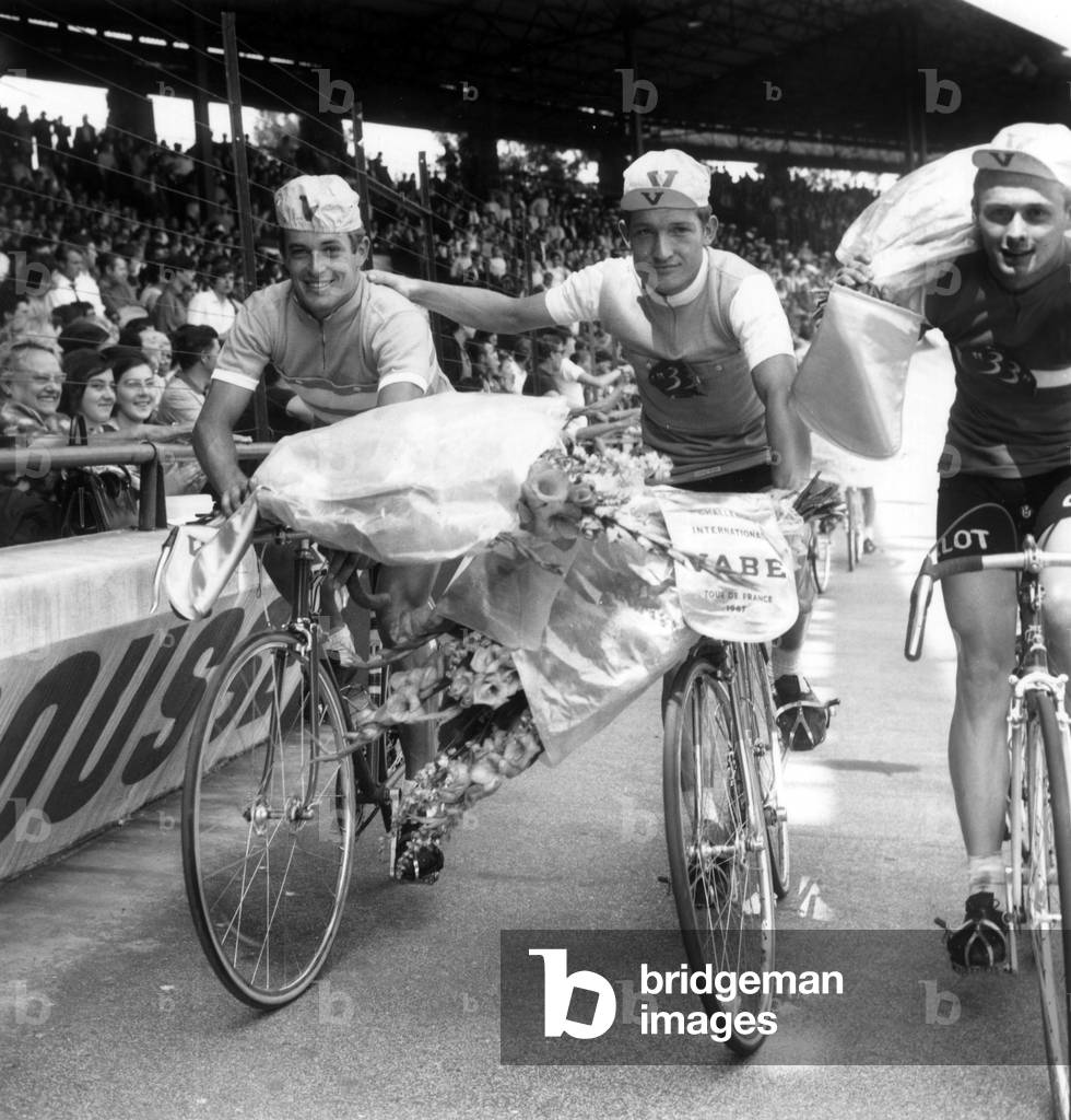 Christian Robini and Cyrille Guimard Take A Tour Of Honour After Arriving In The Tour Of The Future Winners At Parc Des Princes On July 23, 1967 (b/w photo)
