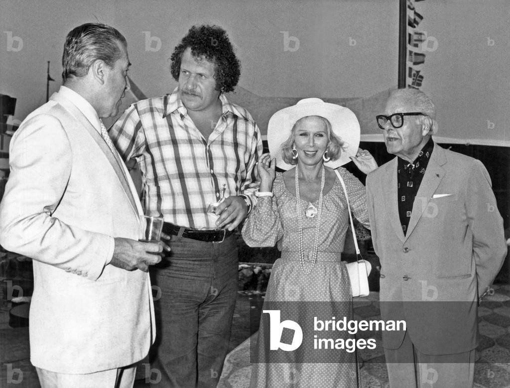 Singer Mort Shuman Has Received A Prize (Kindness Prize) on June 29, 1974 at Time of Reopening of The Casino in Antibes (French Riviera) : L-R : Lucien Barriere, Mort Shuman, Martha Barriere (Lucien Barriere'S Wife), Andre Luguet (b/w photo)