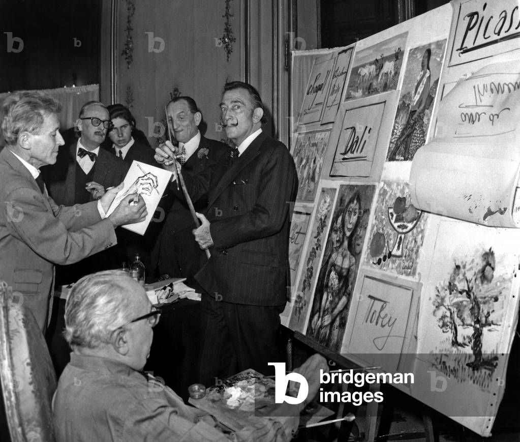 Painter Mac Avoy Buying A Drawing By Salvador Dali While Jacques Favre De Thierrens Is Drawing. Benefits of The New York Auction Goes To The 'Societe Des Amis De L'Enfance', November 4, 1966 (b/w photo)