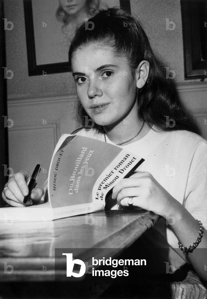Minou Drouet, Young French Writer Sign his Book Du Brouillard Dans Les Yeux at his Home, October 17, 1966 (b/w photo)