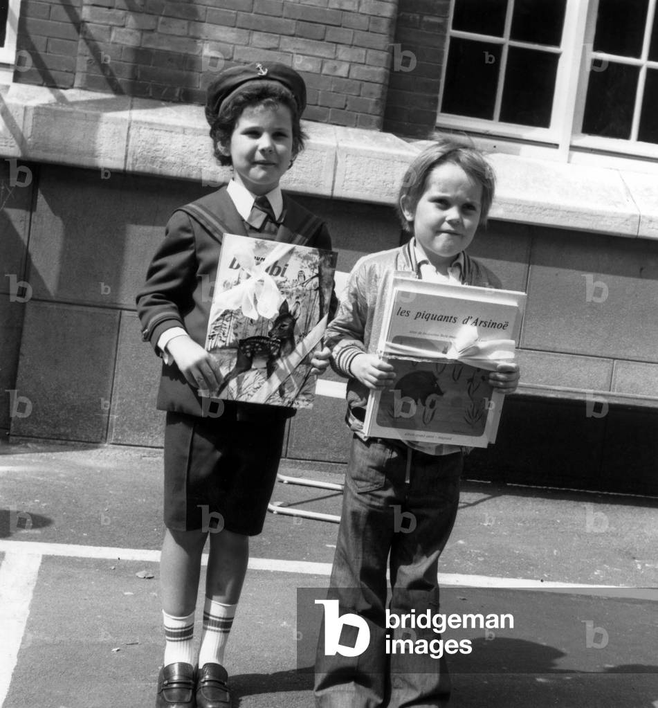 Two students from the Neuilly School show the Fine Books they received in reward on June 23, 1973. (b/w photo)